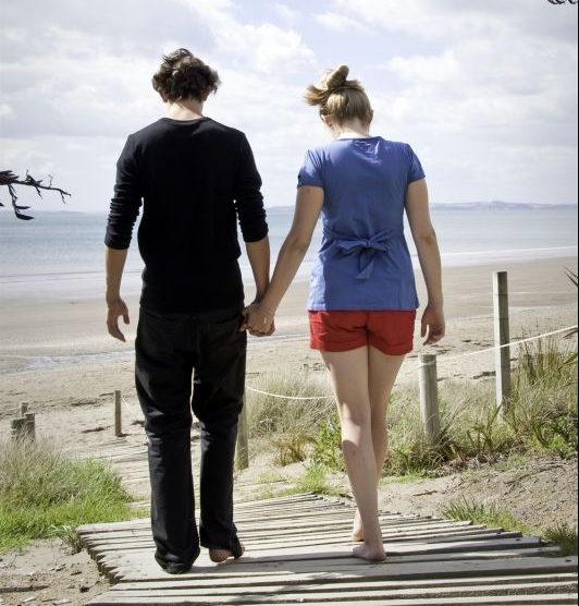 Man and woman walking on beach